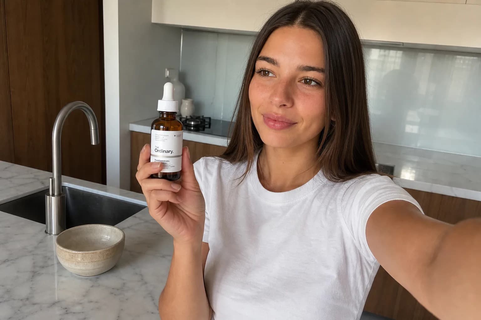 Woman filming a product review video on her phone in a bright kitchen