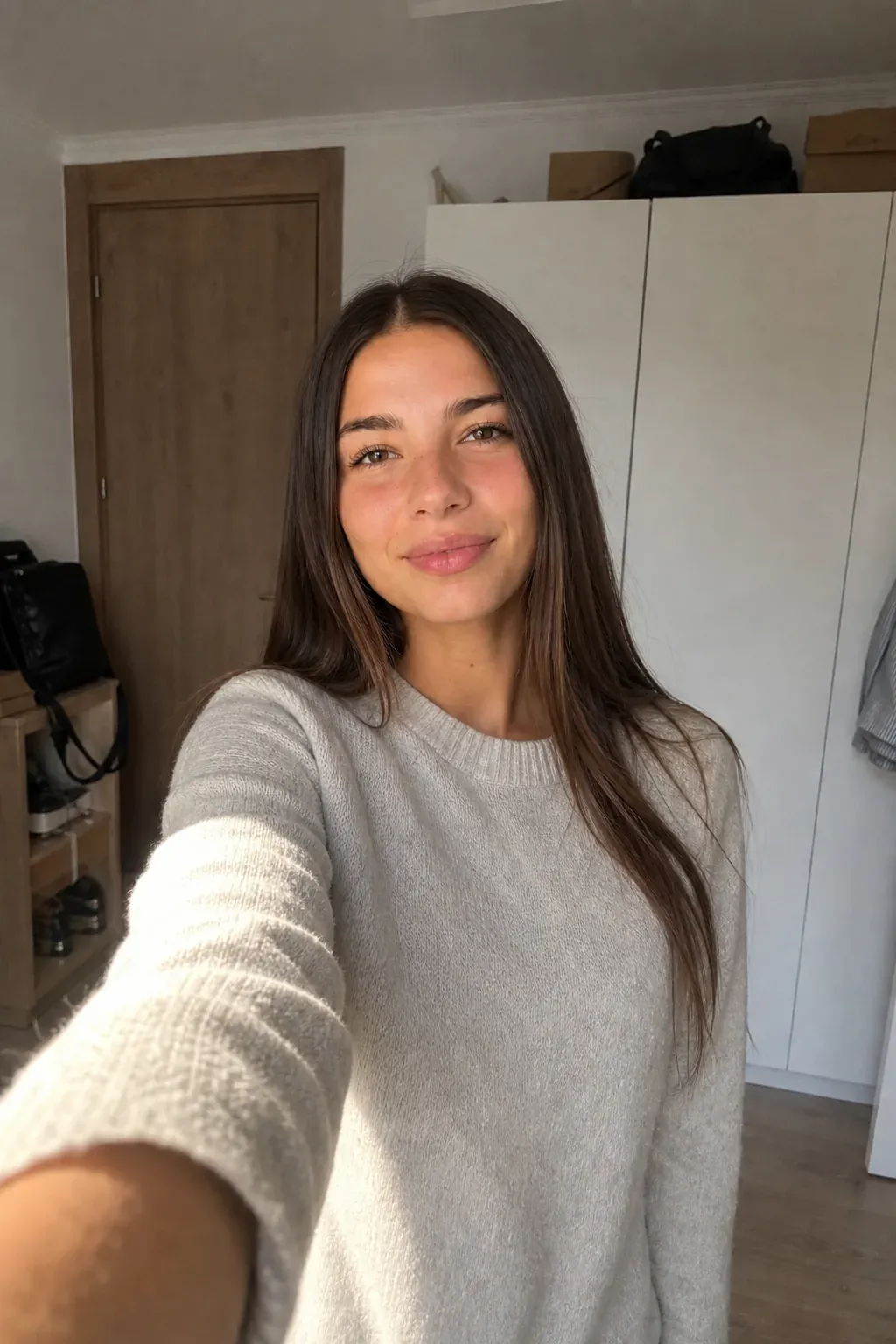 Lera Brune in a sunlit bedroom, beige cashmere knit sweater. AI character generated on Cladegrove